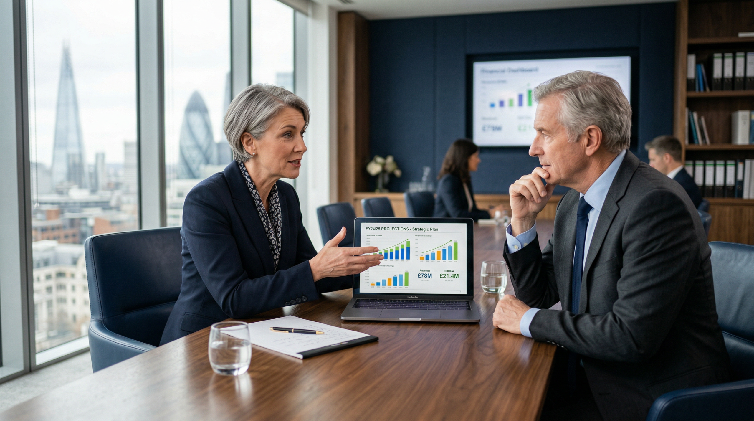 A fractional CFO discussing financial strategy with a business owner in a modern UK office