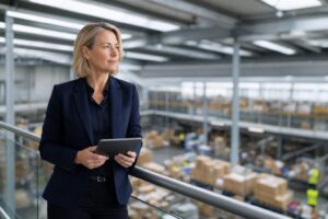 UK operations director on a warehouse mezzanine overseeing a modern distribution centre